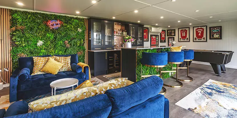 Relaxation room with green living wall and velvet seating